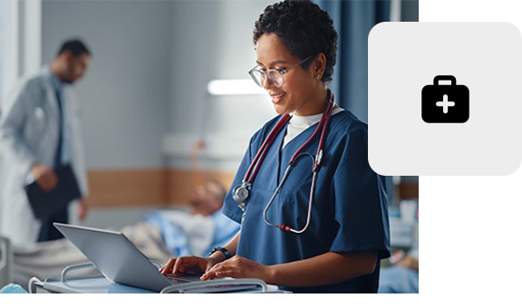 Medical professional working on a laptop in a modern clinic