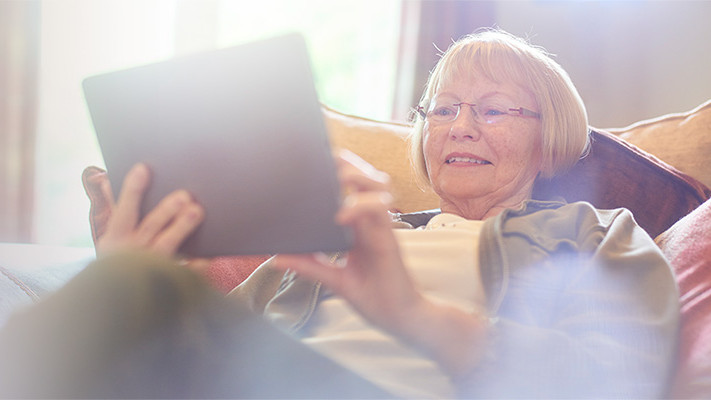 Elderly woman using the Brain+ health app for digital HealthCare