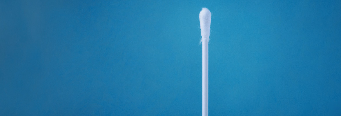 PCR test swab against blue background