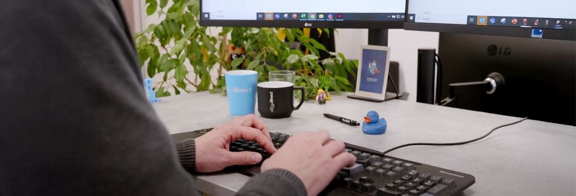 Person typing on a computer keyboard 