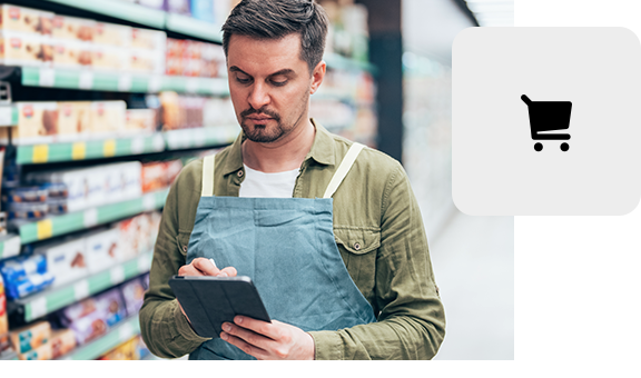Retail employee checking inventory with a tablet in a supermarket.