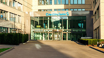 Exterior view of the Creditreform office building with glazed entrance area and company logo